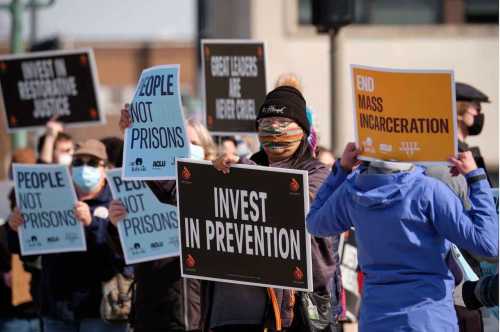 Protest attendees call for investments in prevention instead of a new prison.